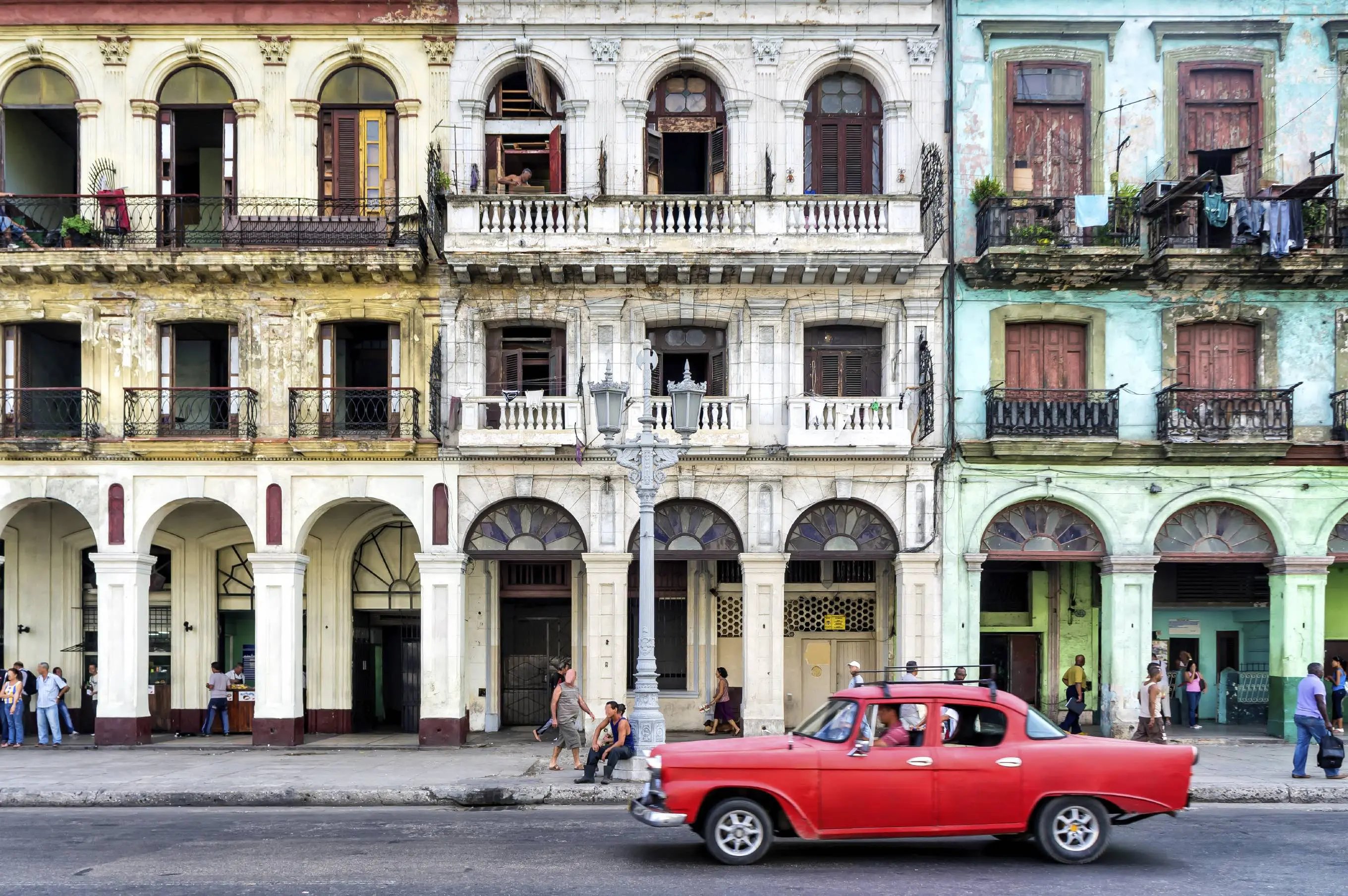 Top 10 best value destinations for 2016 25 Street scene with vintage car and worn out buildings in Havana, Cuba.