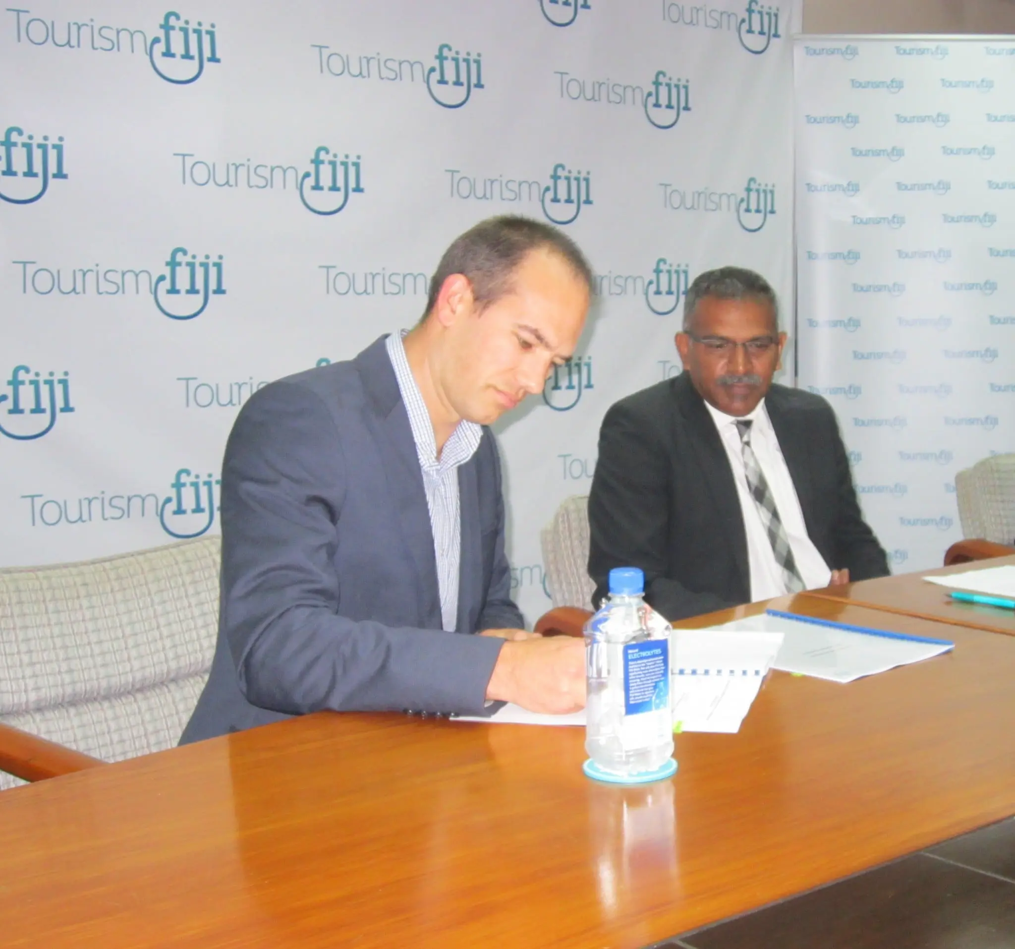 Mr Mathew Stoeckel signs his contract with Minister for Tourism at Tourism Fiji Head Office.