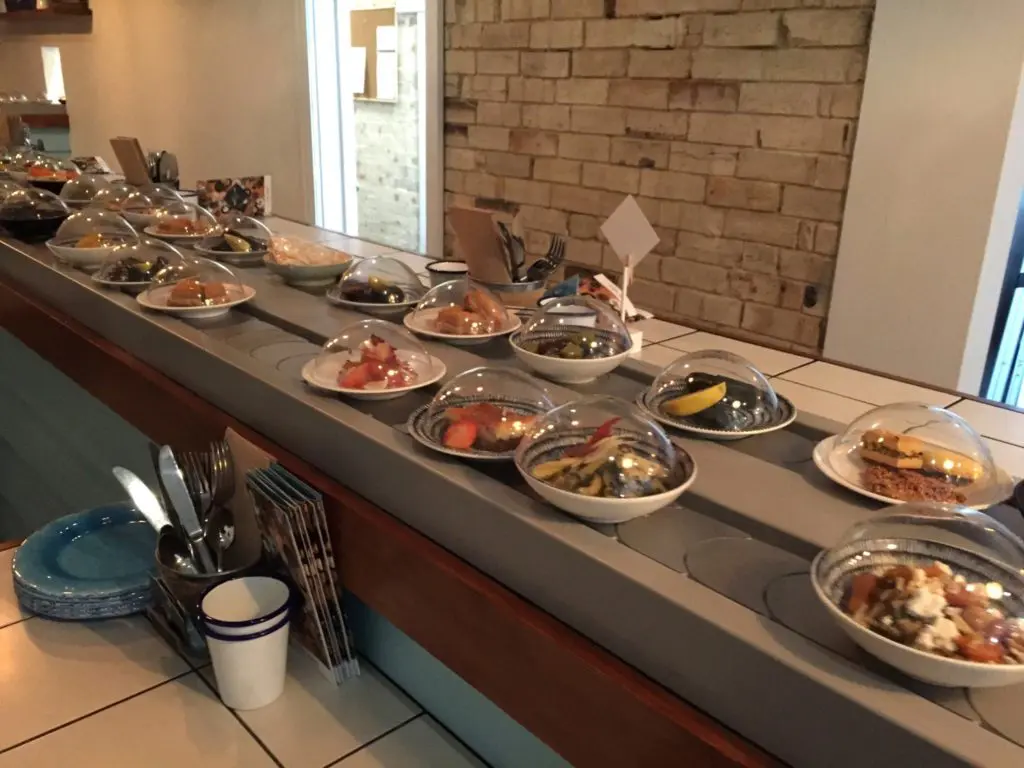 Mediterranean food riding a sushi train at MediTrainean