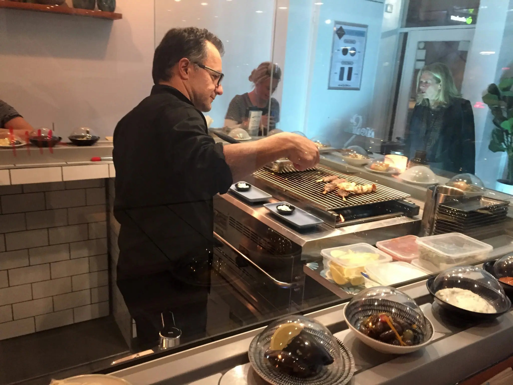Mediterranean food riding a sushi train at MediTrainean 1 Flame smoked grill station