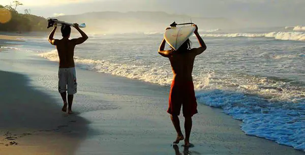 6 of the Best Yoga Retreats for Discovery & Adventure 23 florblanca-surfers-walking-down-beach-2