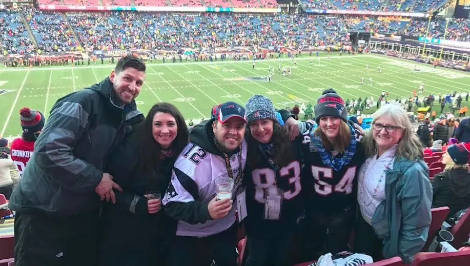 It looks like a picture of friends at a sports game, but the details behind it will make you smile