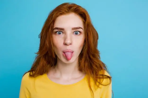 10 CLASSIC TRAVEL AGENTS QUOTES THAT WILL BE REMEMBERED FOREVER 35 headshot-portrait-of-happy-ginger-red-hair-girl-with-funny-face-looking-at-camera-pastel-blue-background-copy-space_1258-799