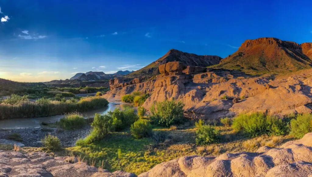 6 reasons why you should add Texas to your next USA trip 7 Red mountains with low shrubs and a river at Big Bend National Park