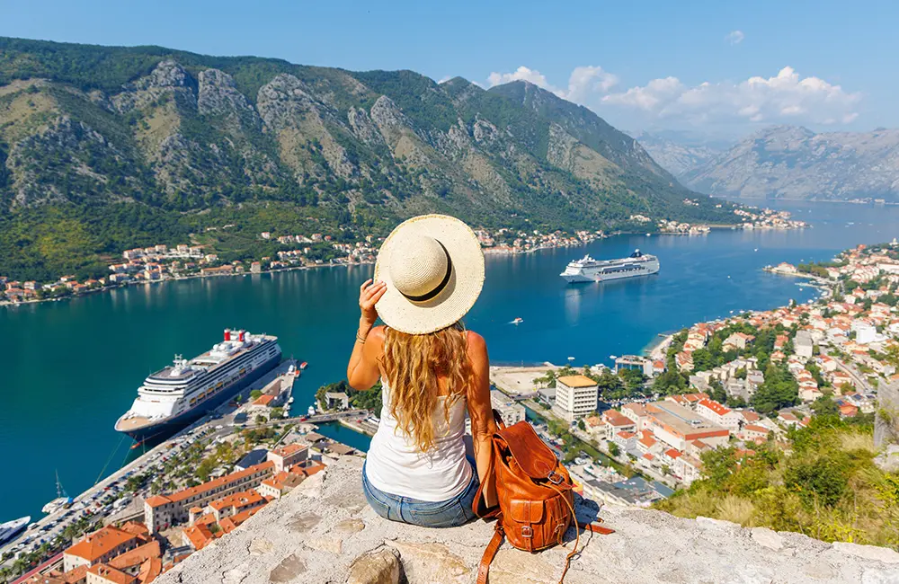 No to overtourism as over-50s drive demand for lesser-known destinations 2 Female tourist in Kotor, Montenegro looking at view lesser-known destinations trends concept