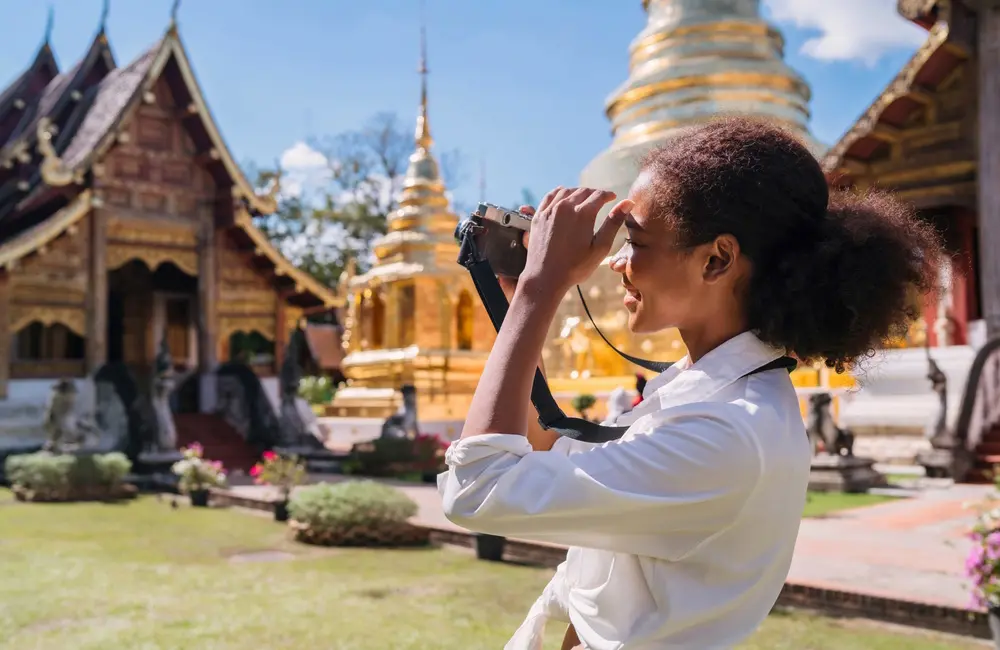 Going your own way? These are the top 10 APAC destinations for Aussie solo travellers 2 Young female solo traveller with camera at temple in Thailand. Aussie solo travellers