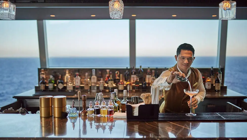 Explora II sets new debut date of 16 September ahead of maiden Mediterranean voyage 4 Explora II barman and bar.