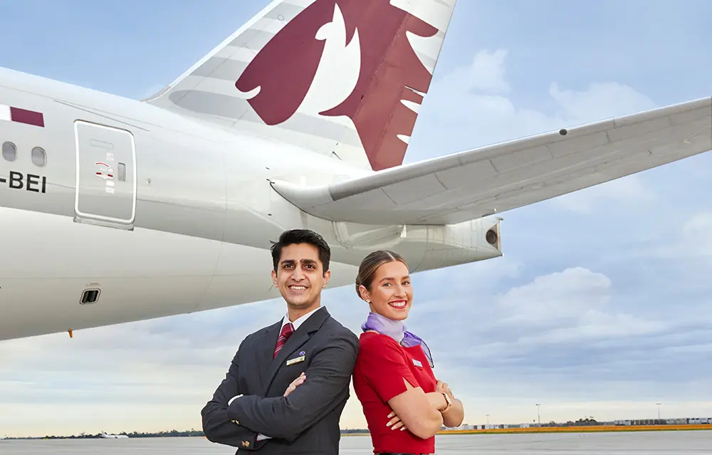 Qatar Airways and Virgin Australia flight attendants stand back to back in front of Qatar Airways plane on airport tarmac. Karryon Top 10 stories of the week
