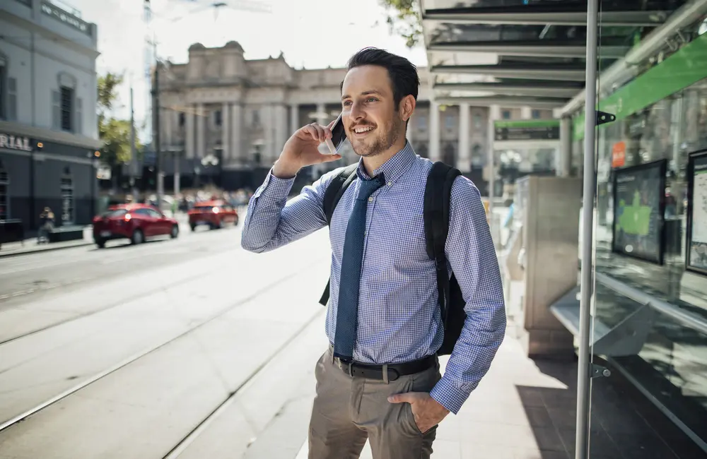 This APAC capital ranks as world’s best workation city for bleisure travellers in 2025 3 Male millennial business traveller talking on smartphone at tram stop in Melbourne CBD.