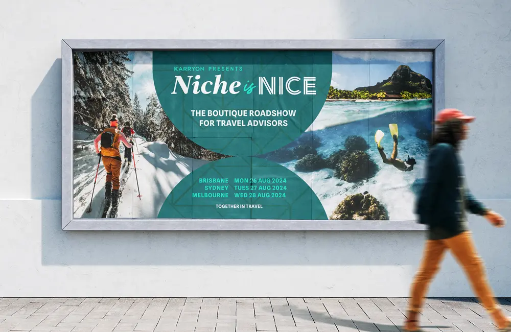 Female walking past billboard promoting Niche is Nice boutique roadshow for travel advisors.