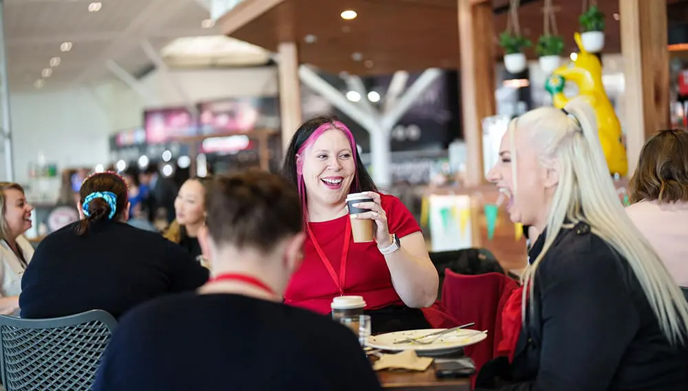 All aboard! Flighties go beyond the gates on special Air Canada & Brisbane Airport famil 3 Flight Centre consultants eating breakfast at Brisbane Airport cafe.