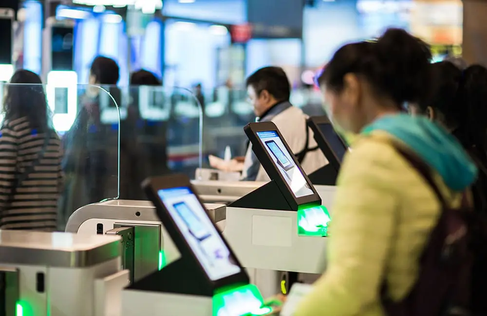 Passengers using SmartGate facial recognition technology at Australian airport.