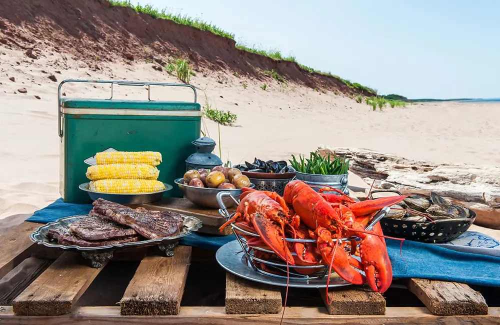 Fall for Canada in autumn: Open yourself up to culture, nature, culinary & more 6 Seafood spread on beach for Prince Edward Island's Fall Flavours Food & Drink Festival