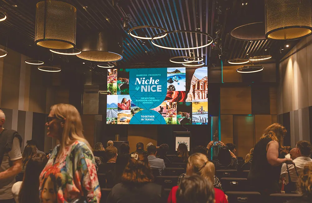 Less than 2 weeks to go until Niche is Nice 2025 & $20K in prizes! Are you on the list? 11 Screen with 'Niche is Nice' within presentation theatre among travel agents.
