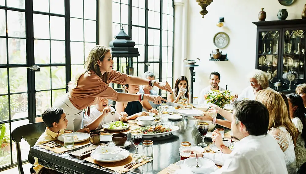 Family and friends around a festive table setting.