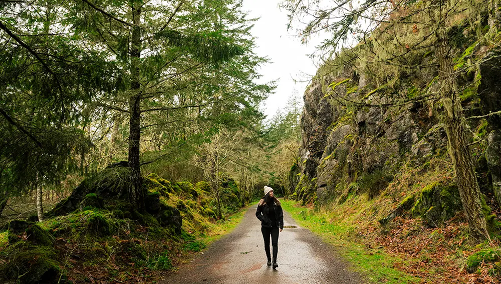 Woman walking in Goldstream Provincial Park on Vancouver Island. Image: Destination BC/Jordan Dyck – Travel With Purpose Ambassador competition