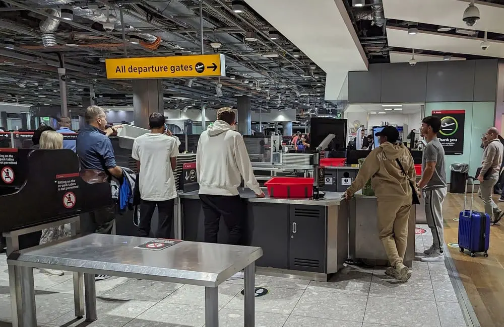 Passengers wait for security screening at London Heathrow Terminal 3.