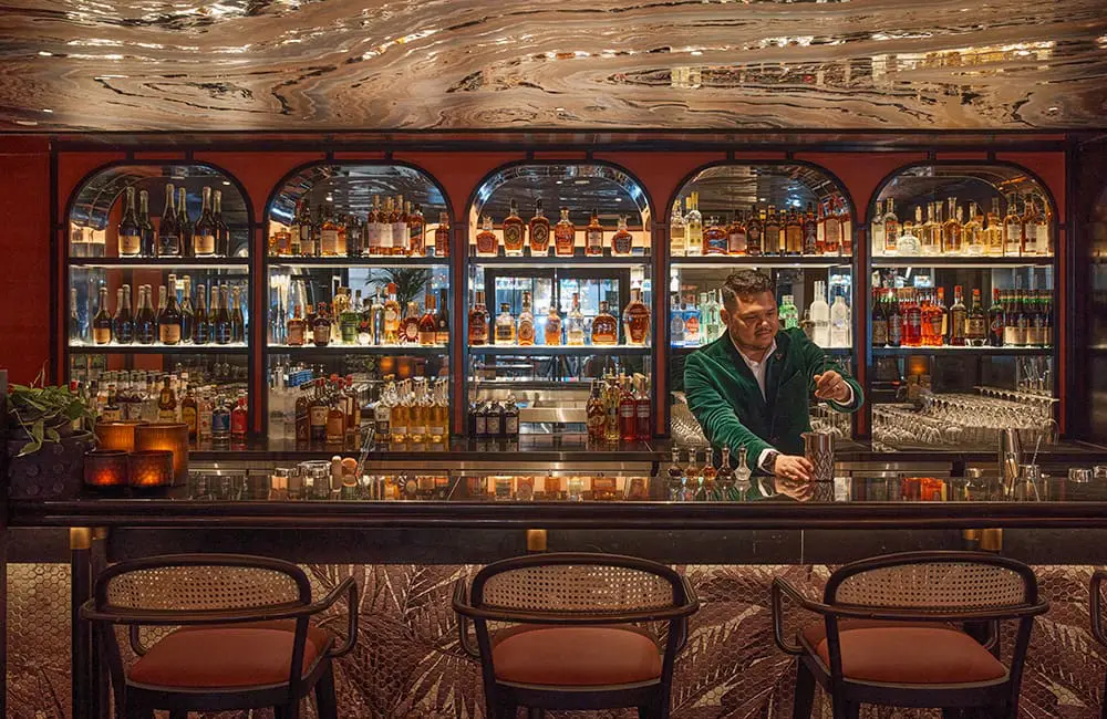 QT Singapore hotel is now open as brand expands to South-East Asia 4 Cygnet bar at QT Singapore with barperson making cocktail.