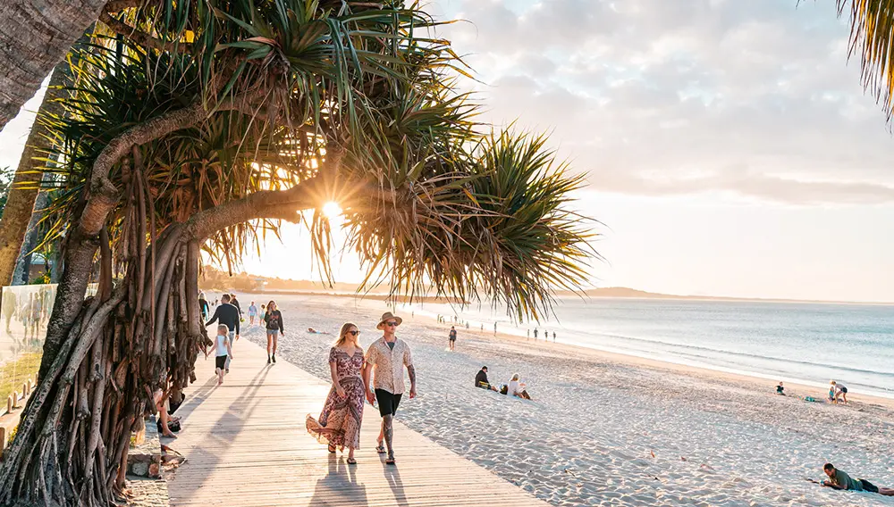 Movers + Shakers: Gate 7 onboards Account Director NZ for new TEQ representative appointment 3 Couple walking on the boardwalk at Noosa Heads Main Bach on the Sunshine Coast.