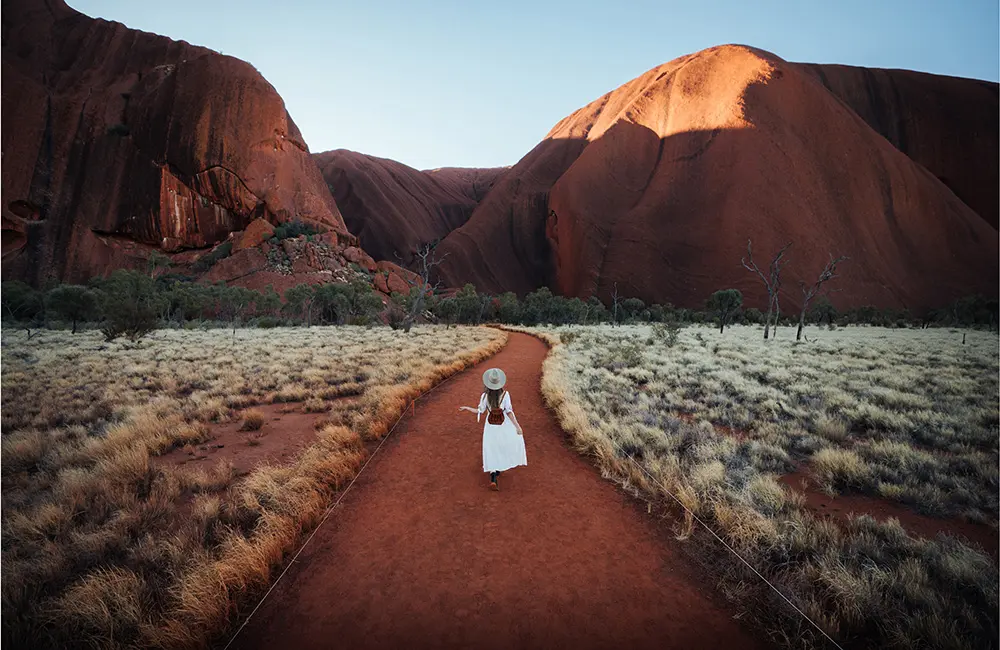 ATEC urges action as outbound travel outpaces inbound holiday visits, down 20% on 2019 2 Woman walking near Kata Tjuṯa (The Olgas) in the Northern Territory.