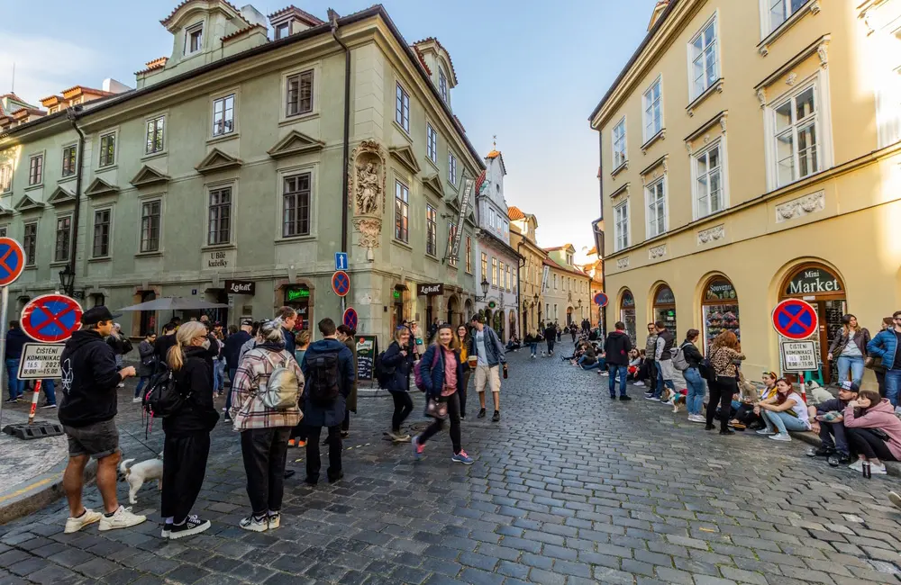 Prague puts the kibosh on pub crawls as the latest European city to crack down on overtourism 2 People drinking outdoors during COVID in Prague's historic city centre. Image: Matyas Rehak/Shutterstock