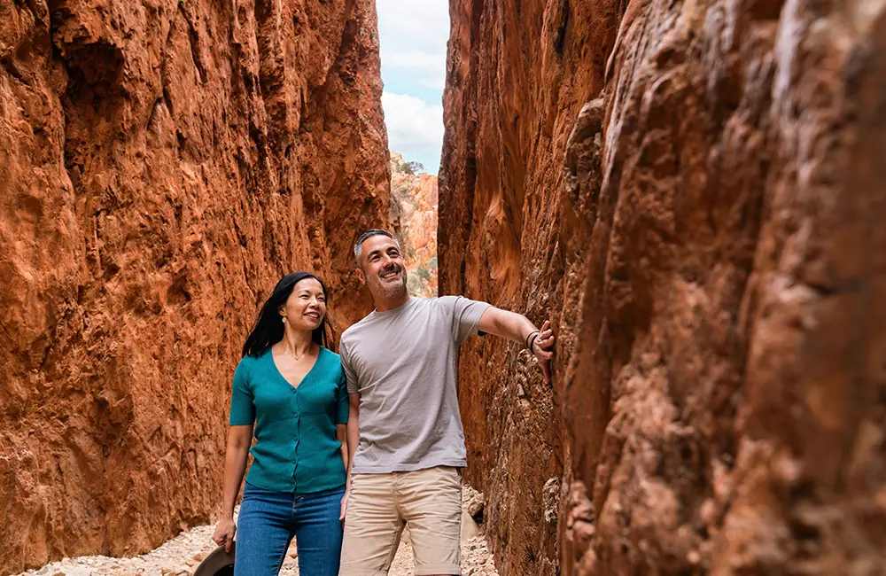 Couple walking in Standley Chasm – Angkerle Atwatye. Image: Tourism NT/Shaana McNaught