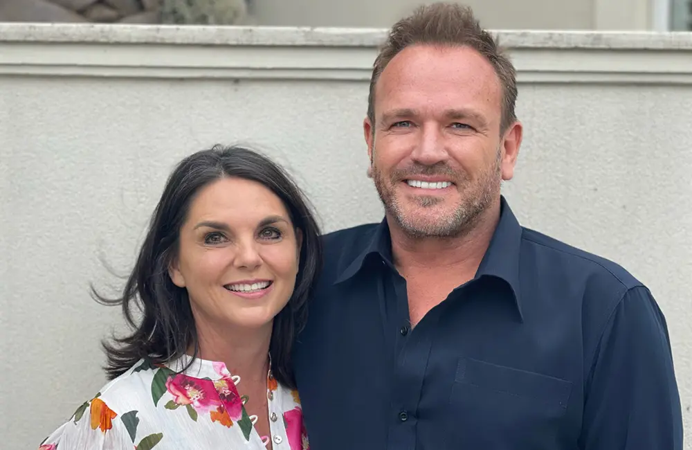 CT Partners expands global reach with unified Gray Dawes Travel membership 1 Corporate image of couple against building background.