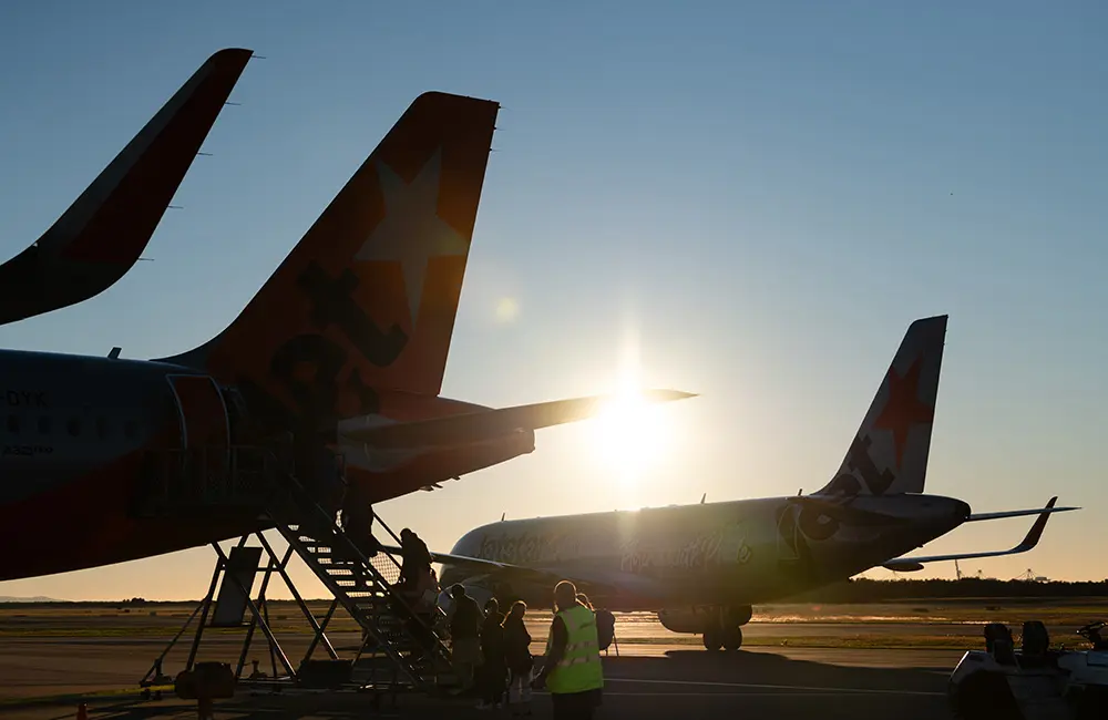 Brisbane Airport breaks two records in one day –including its busiest 24 hours since 2019 3 Passengers lining up for Jetstar flights on the tarmac at sunrise at BNE. Image: BAC