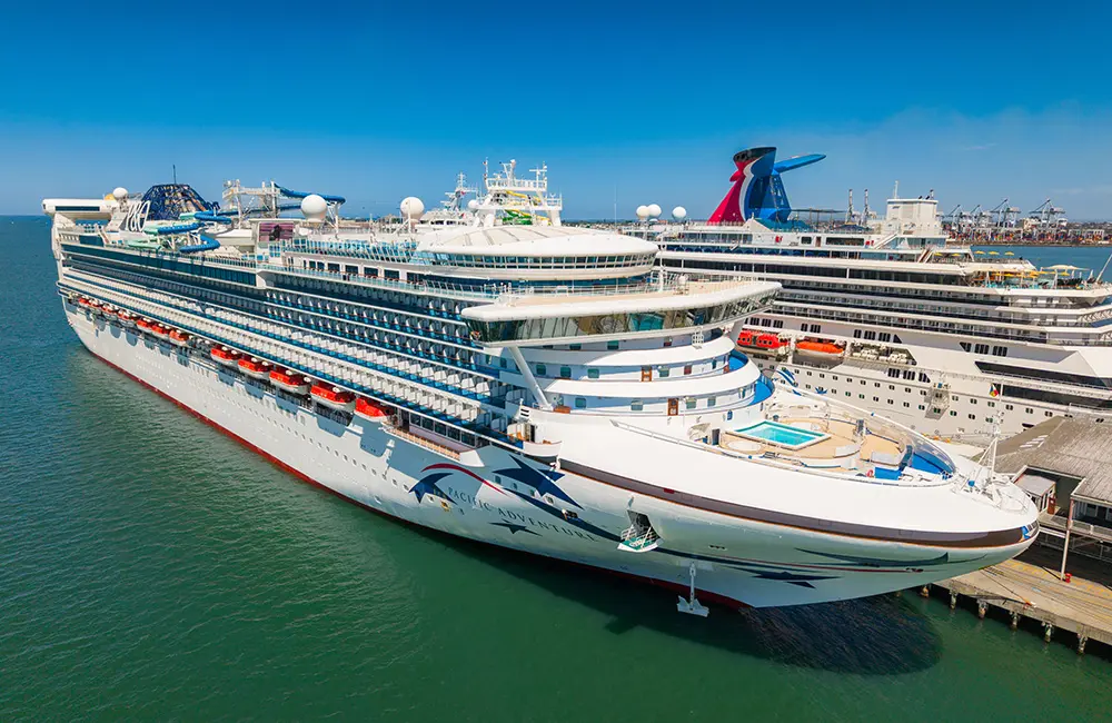 Carnival’s two Australia-based ships are Asia-bound for the first time in 2026-27 2 Pacific Adventure docked near a Carnival Cruise Line ship.