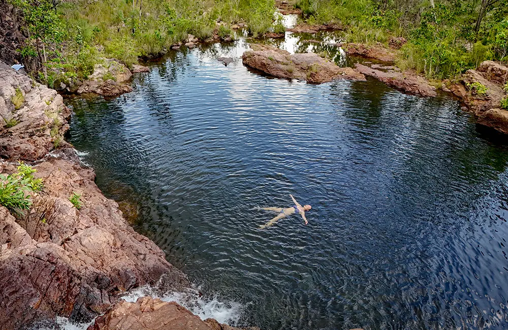 This familiar Aussie face is dishing the goods as the Northern Territory’s newest ambassador 1 Aerial image of woman swimming at Litchfield National Park’s Tjaynera Falls (Sandy Creek Falls). Credit Toby Zerna for Tourism NT