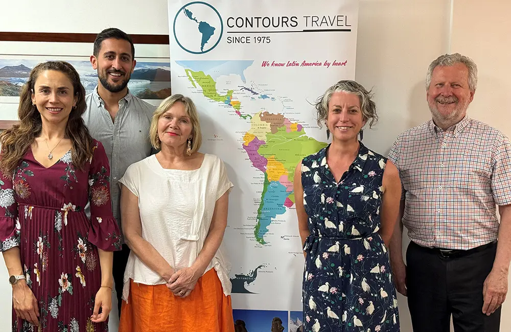 Movers + Shakers: Contours Travel Founder Ted Dziadkiewicz steps down after 50 years 4 Contours Travel team in front of signs in office.