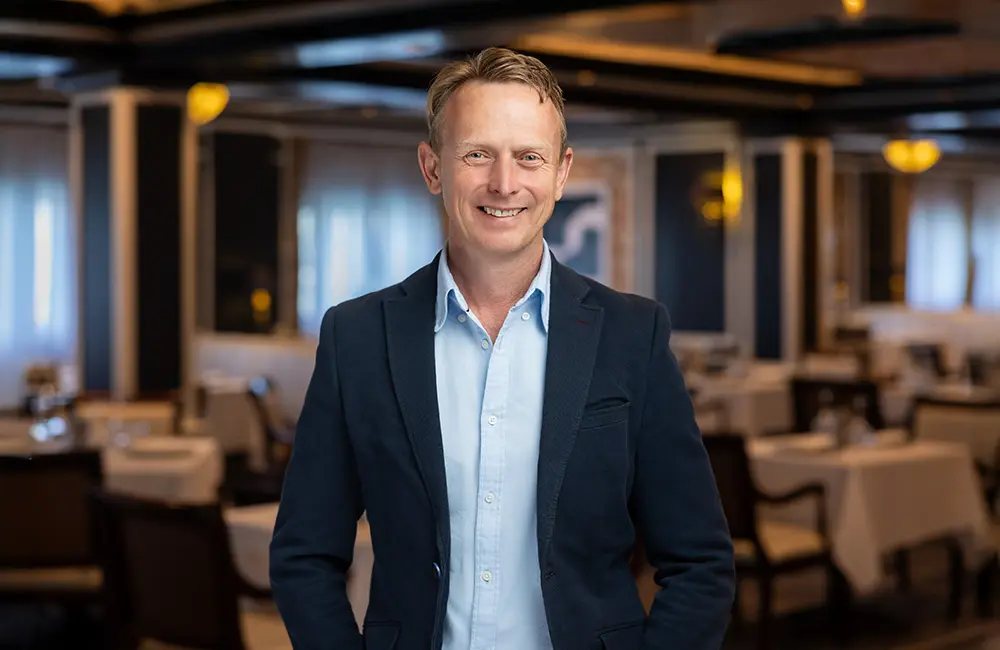 Corporate headshot of man in cruise ship restaurant