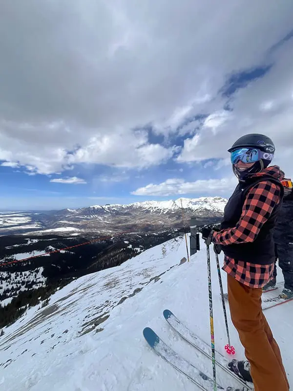 Snow place like Colorado! 30 agents return from unforgettable Sno'n'Ski 2025 Mega Famil 9 Skier at top of mountain in Colorado on on the Sno'n'Ski 2025 Mega Famil.