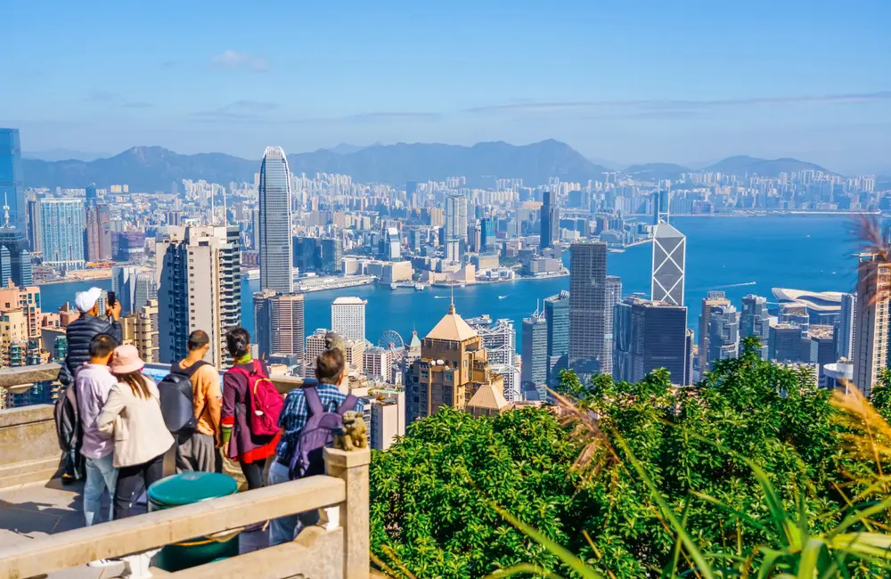 After a 5-year absence, Cathay Pacific returns to this state, completing its Aussie comeback 1 Tourists take in the view of the Hong Kong skyline and Victoria Harbour from Victoria Peak.