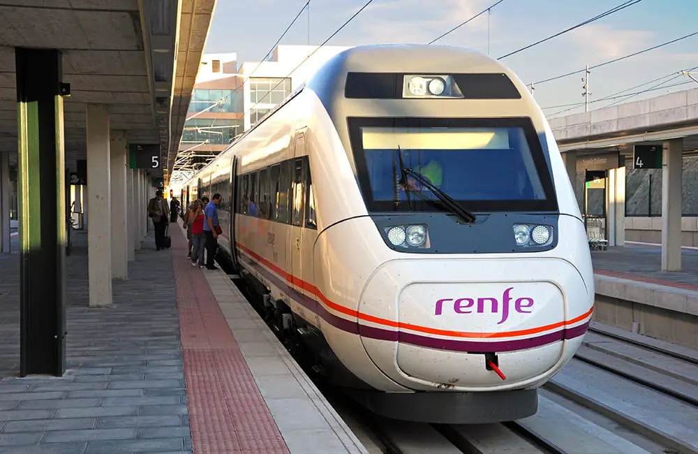 Seamless Spain by train: Rail Europe now offers Renfe reservations for Eurail Passes 2 Renfe train at station in Spain.