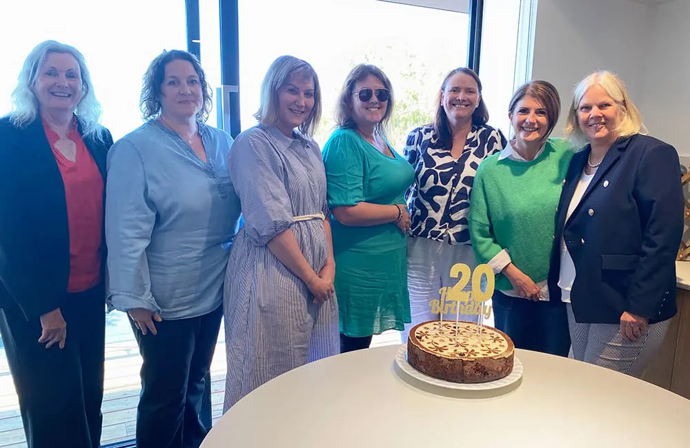 Group of TravelManagers personal travel managers with cake in Hobart.