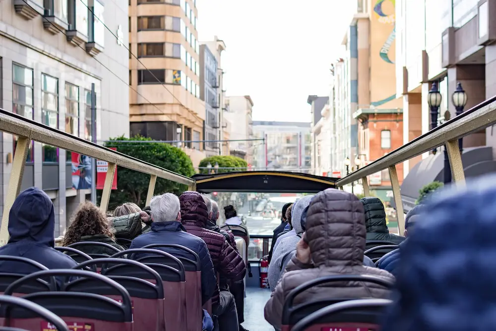 1 in 2 US tourism businesses, destinations report decline in present & future travel: major survey 2 Tourists while enjoying the ride from a double decker bus of Big Bus Tours in San Francisco California USA. Tourists on a bus while doing the city tour. Bus tour service photo