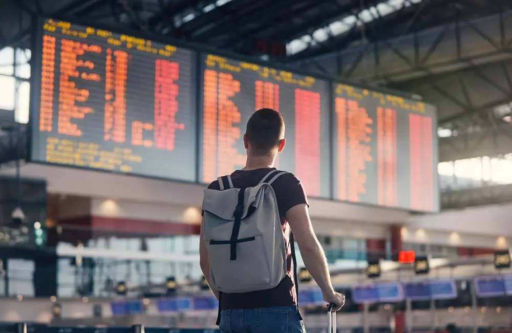 Karryon Top 10 stories of the week: Catch up on our most-wanted: May 16 2 Male traveller with back to camera looking at airport information board. Karryon Top 10 Stories