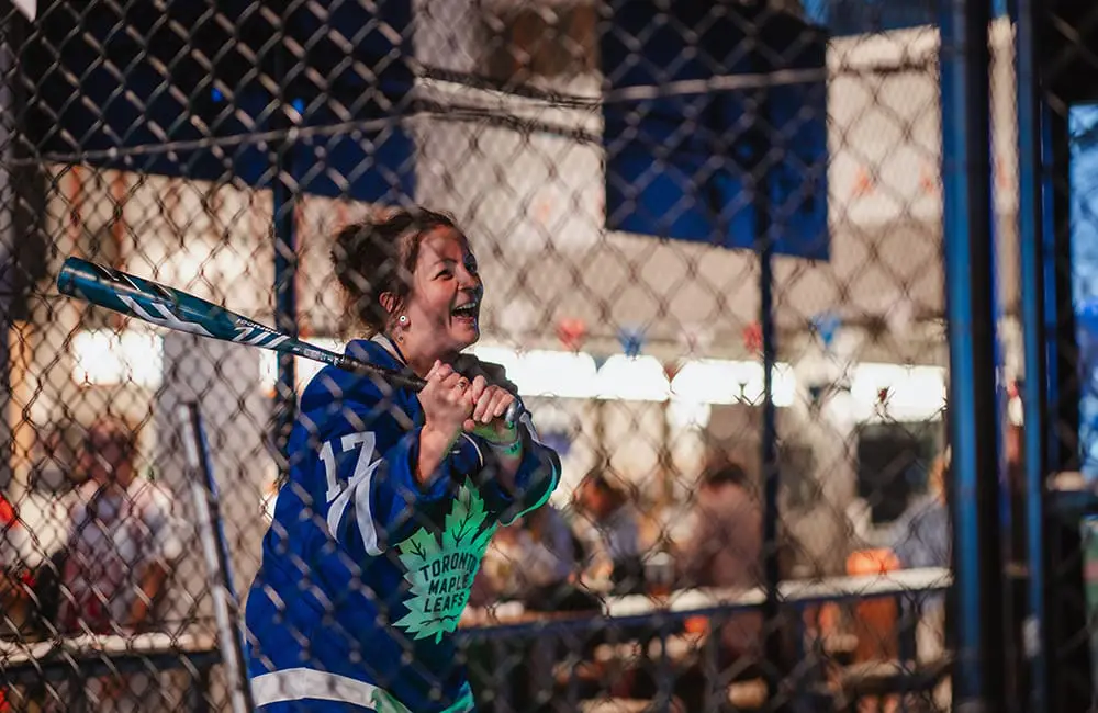 Brisbane swings big with bumper turnout at U-S-eh event with BNE, Air Canada & Linkd Tourism 7 Woman in baseball batting cage.