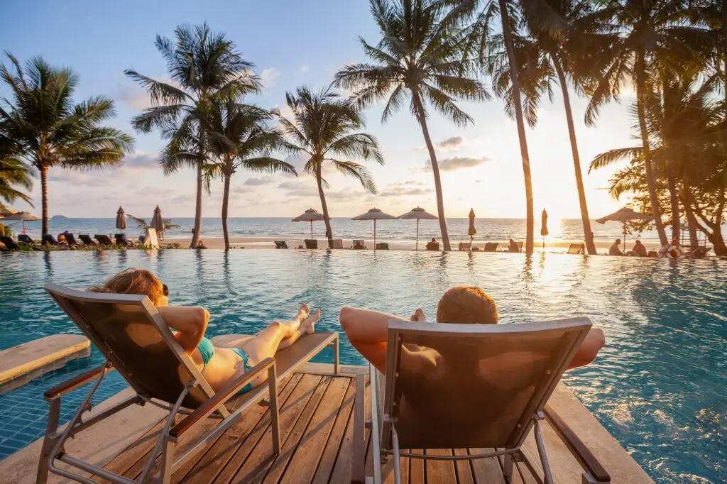 Travel Beyond Group acquires luxury agency Out and About Travel 1 vacation, couple on the beach near swimming pool, luxury travel