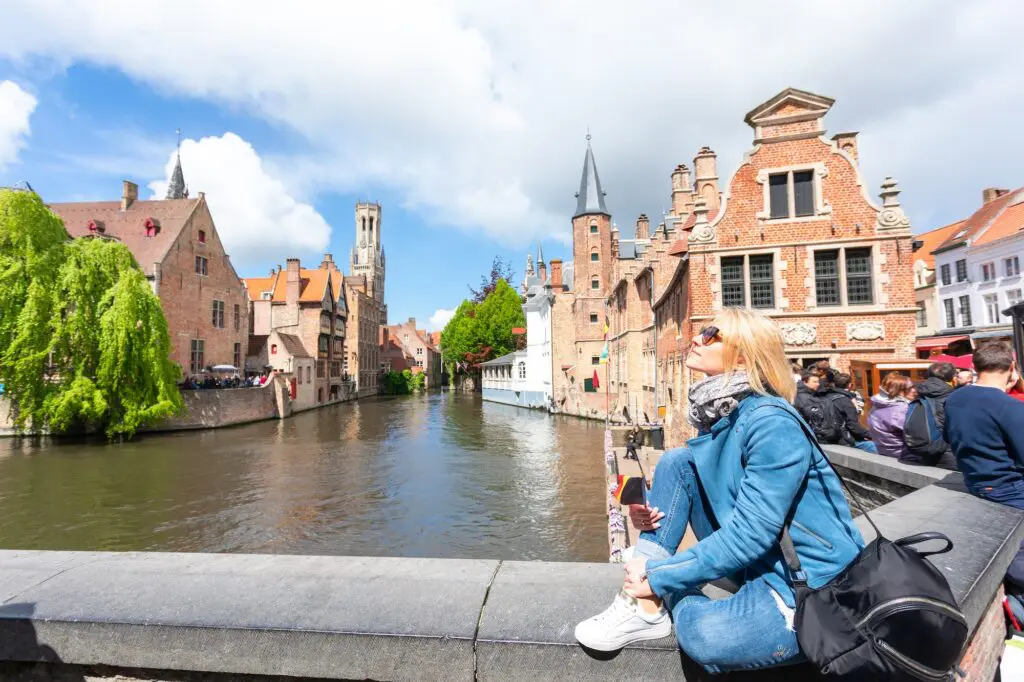 Karryon Top 10 stories of the week: Catch up on our most-wanted: May 16 10 Young woman tourist with the flag of Belgium in the hands is enjoying the views of the city in the historic center of Bruges near the famous viewport. Travel to Belgium.