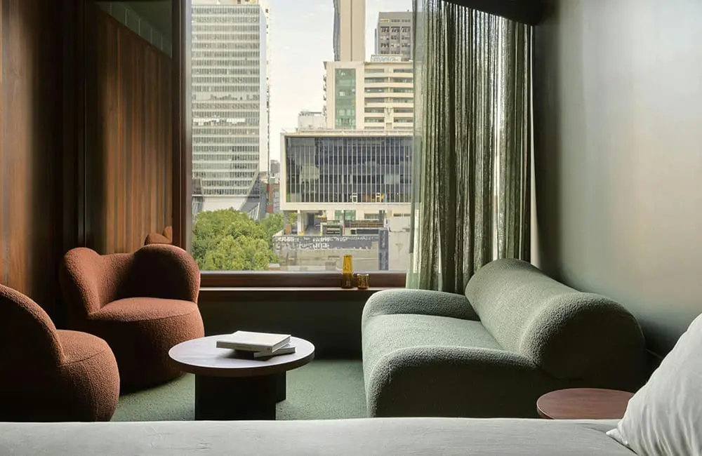 Ennismore's Hyde hotel brand has just debuted in Australia in this capital city 4 Urban guestroom lounge area at Hyde Melbourne Place hotel.