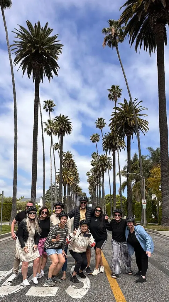 LA Tourism & Infinity Holidays launch new incentive after Aussie agents return from co-hosted fam 3 LA Tourism x Infinity Holidays famil group on road with palm trees.