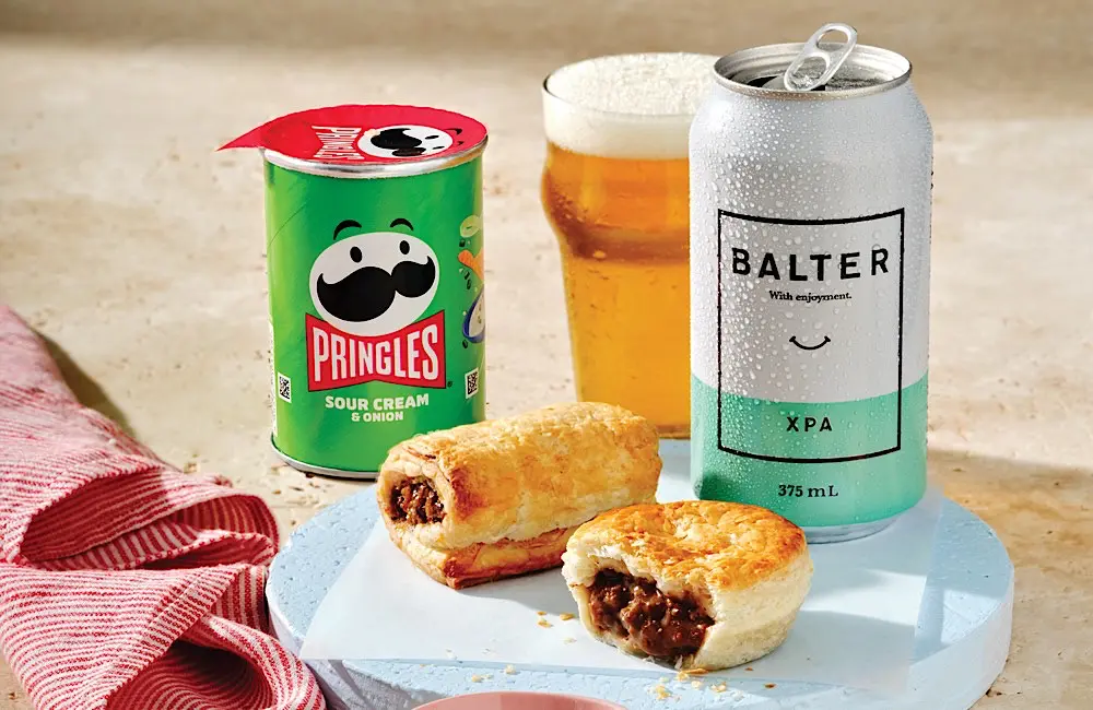Tray tables down: Virgin Australia’s winter menu is anything but plane food 1 An Aussie snack trio: Beef pie, sausage roll, and Balter XPA. Virgin Australia’s Economy menu goes full comfort mode.