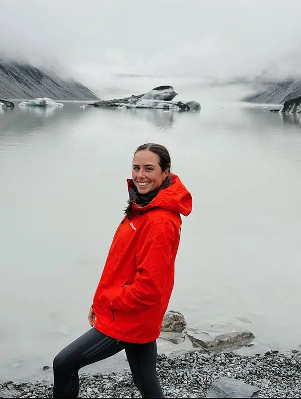 Kayak in Antarctica with Intrepid Travel Ambassador & Olympian Noémie Fox in 2026 2 Intrepid Travel ambassador & Olympic gold medallist Noémie Fox in New Zealand at edge of lake.