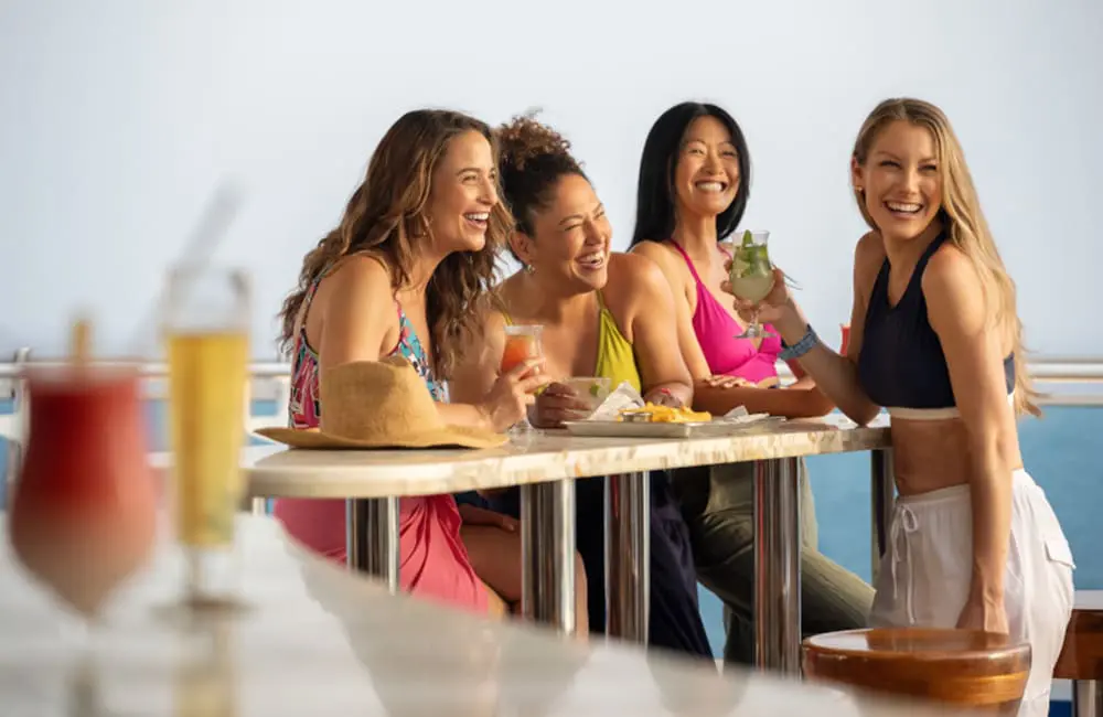 Princess Cruises' Nick Ferguson on what Aussie cruisers want & where they want to go in 2025 7 Female friends at Wake View Pool bar on Princess Cruises ship.