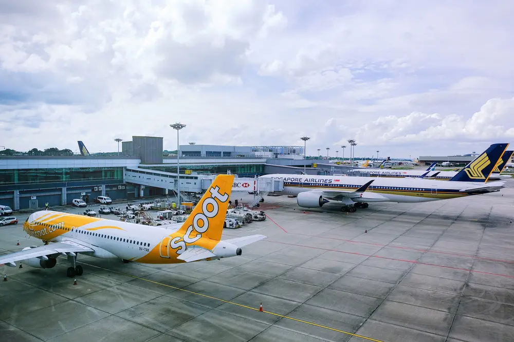 Scoot & Singapore Airlines planes parked at Changi Airport.