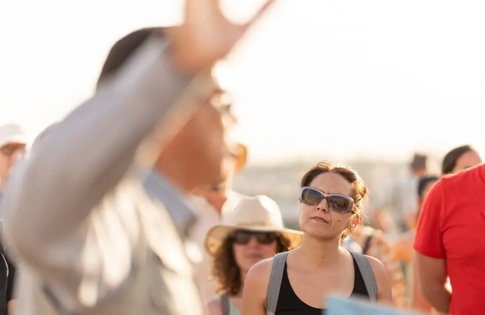 Close-up of tour guide leading group outdoors for CATO touring report