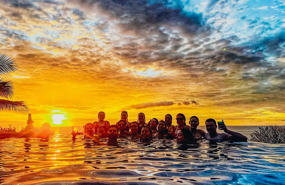 Movers + Shakers: TruTravels establishes first-ever Australia-based reservations department helmed by res guru Drew Appleton 2 Group of youth travellers in an infinity pool at sunset on a TruTravels Costa Rice Adventure tour.