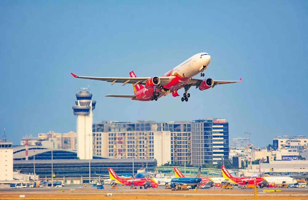 Vietjet drops Australia–Vietnam one-way fares from $199 plus bag perks & gift packs 2 Vietjet aircraft takes off from airport with other planes on tarmac.